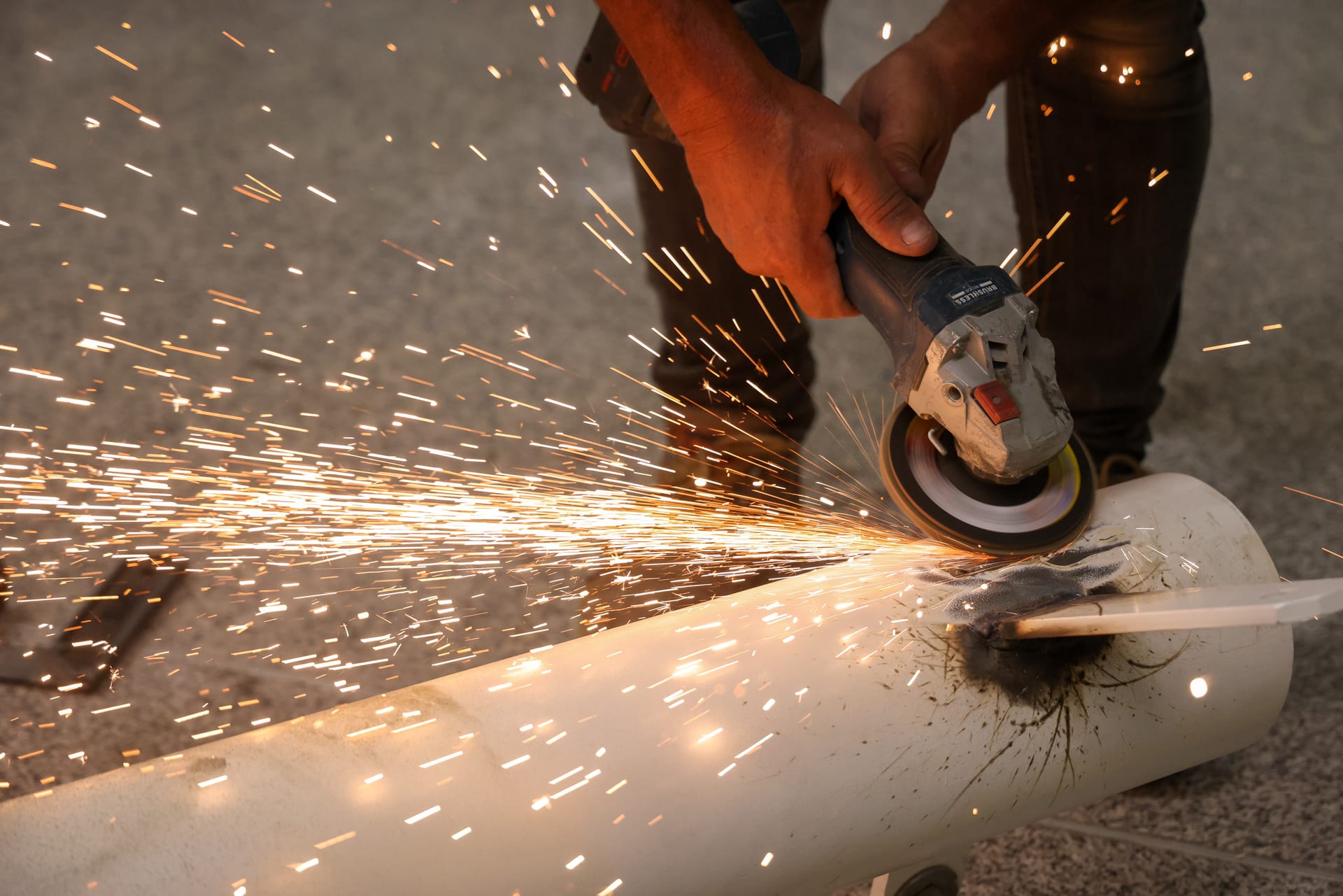 Angle-grinder cutting – sparks on a JAF site