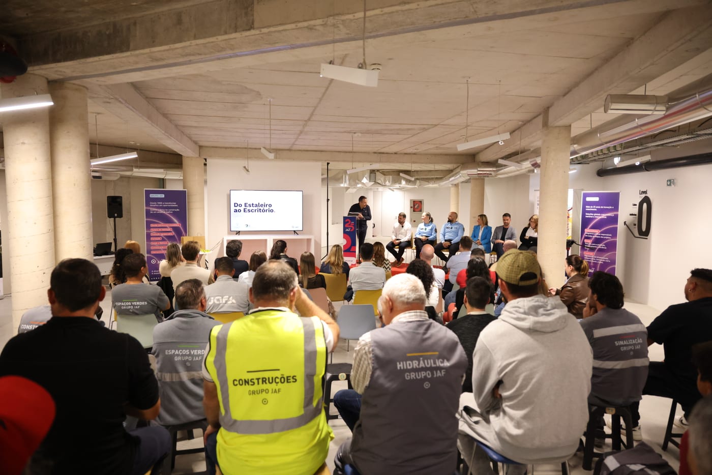 Grupo JAF employees in the uniforms and vests of the Construction, Plumbing, Landscaping and Signage units attending the session